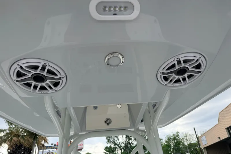 Slide: The Image of 2026 Pathfinder 2400 TRS boat speakers and lighting on T-top, outdoor setting. - 30