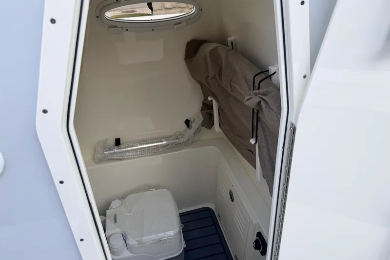 Slide: The Image of Interior of 2026 Pathfinder 2400 TRS boat, featuring compact storage and seating area. - 35