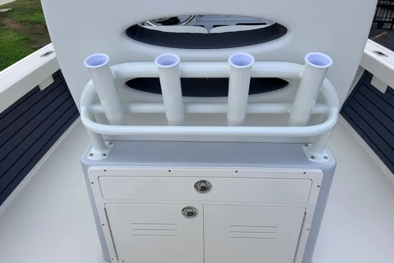 Slide: The Image of 2026 Pathfinder 2400 TRS boat console with rod holders and storage compartment. - 44