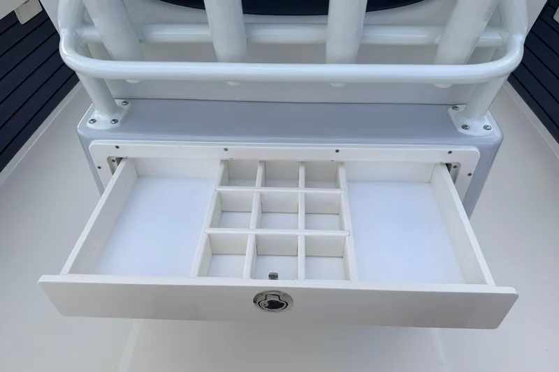 Slide: The Image of Open storage drawer on 2026 Pathfinder 2400 TRS boat, featuring multiple compartments. - 45