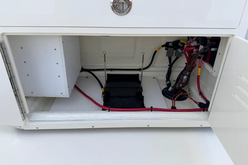 Slide: The Image of Open compartment of 2026 Pathfinder 2400 TRS boat showing wiring and storage space. - 46