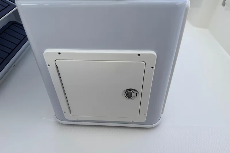 Slide: The Image of 2026 Pathfinder 2400 TRS boat storage compartment with secure latch. - 47