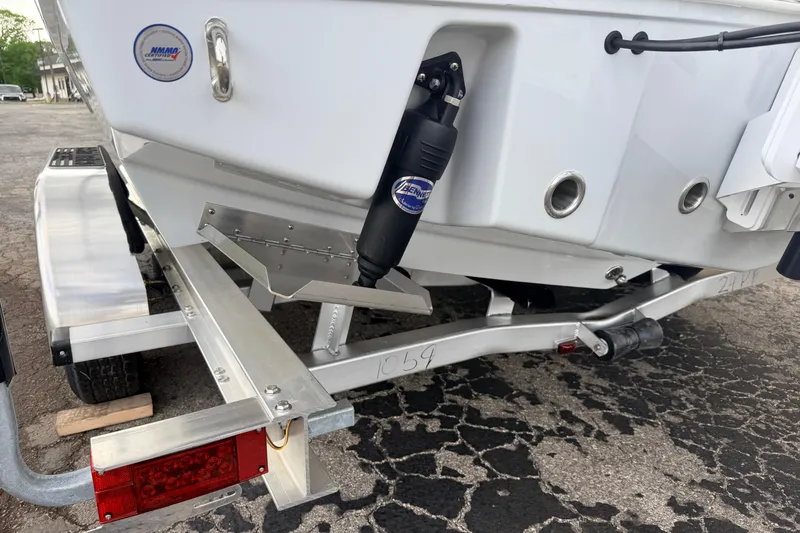 Slide: The Image of 2026 Pathfinder 2400 TRS boat on trailer, featuring trim tabs and hydraulic system. - 5