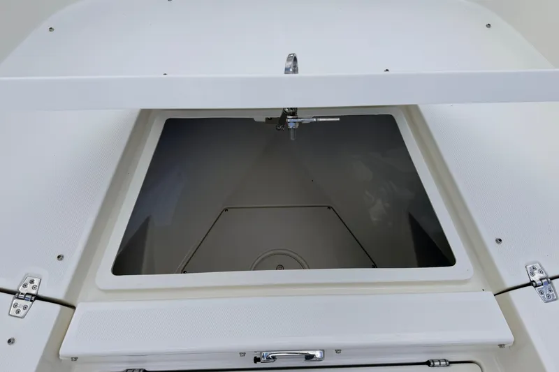 Slide: The Image of 2026 Pathfinder 2400 TRS boat storage compartment with open hatch and secure hinges. - 55