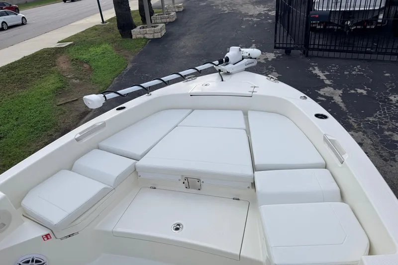 Slide: The Image of 2026 Pathfinder 2400 TRS boat with cushioned seating and trolling motor on deck. - 63