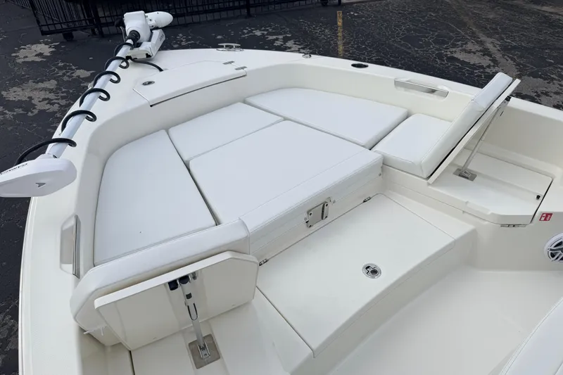 Slide: The Image of 2026 Pathfinder 2400 TRS boat interior with cushioned seating and trolling motor. - 64