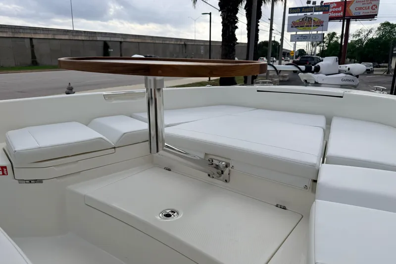 Slide: The Image of 2026 Pathfinder 2400 TRS boat interior with white seating and wooden table. - 66