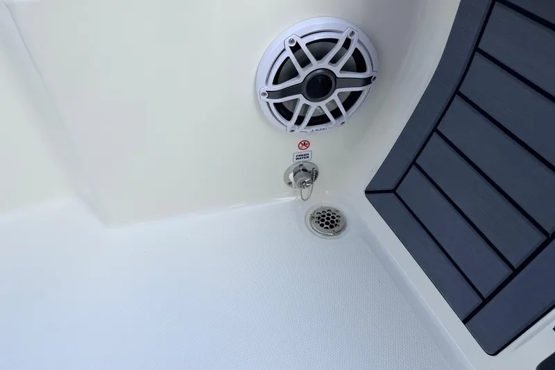 Slide: The Image of 2026 Pathfinder 2400 TRS boat interior with speaker, drain, and textured flooring. - 71