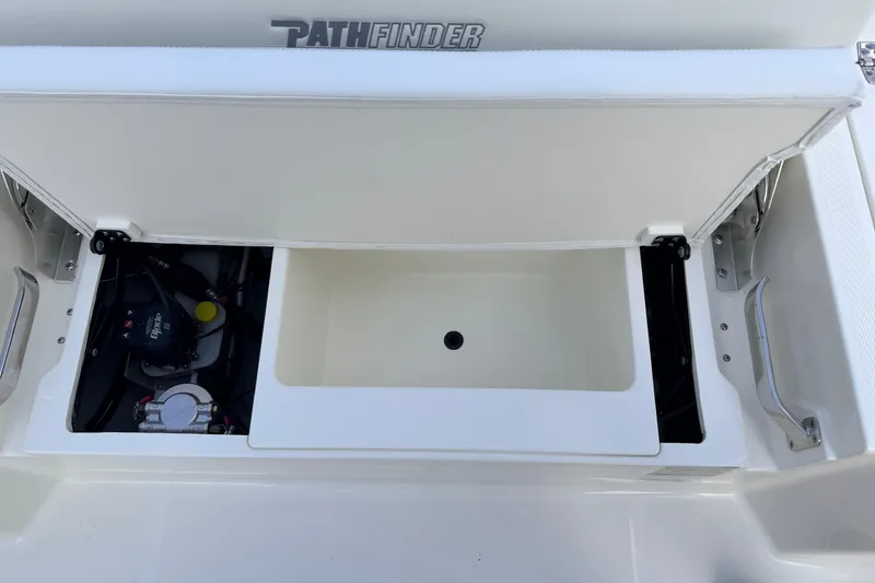 Slide: The Image of 2026 Pathfinder 2400 TRS boat storage compartment with open lid and visible components. - 75