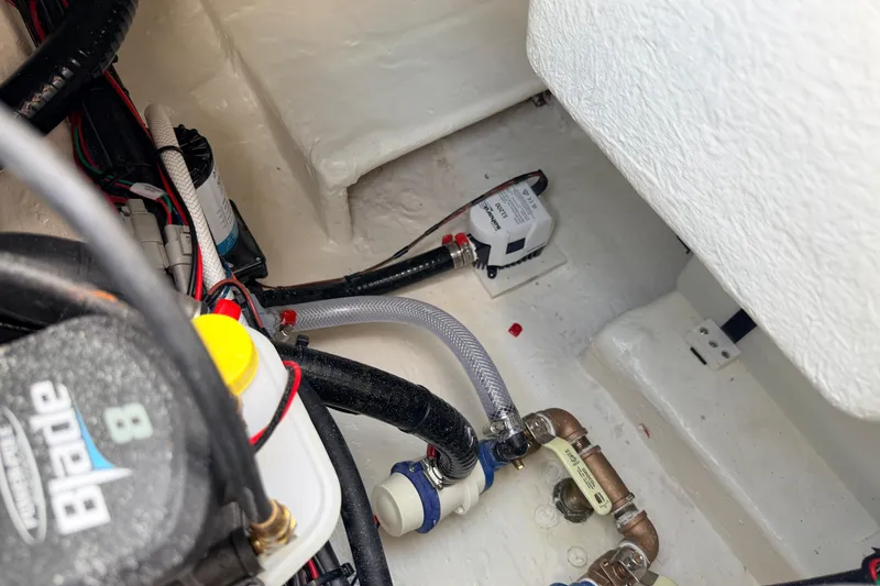 Slide: The Image of Bilge area of 2026 Pathfinder 2400 TRS boat with wiring and pump components. - 77