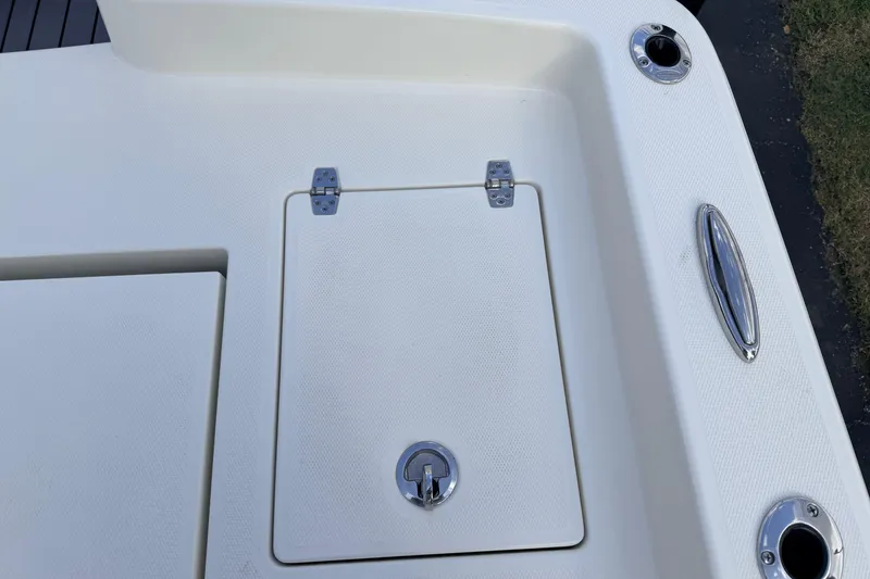 Slide: The Image of 2026 Pathfinder 2400 TRS boat deck with storage hatch and chrome fittings. - 78