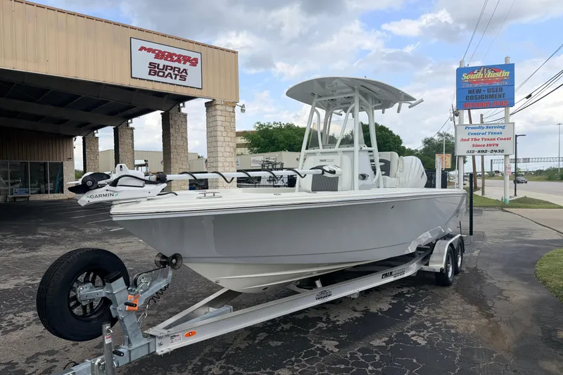 Slide: The Image of 2026 Pathfinder 2400 TRS boat on trailer outside dealership, featuring Garmin equipment. - 9