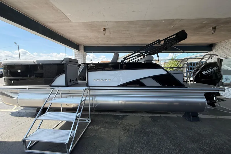 The Image of 2026 Crest Conquest 230 SLSC pontoon boat with Suzuki engine, displayed under a canopy. - 0