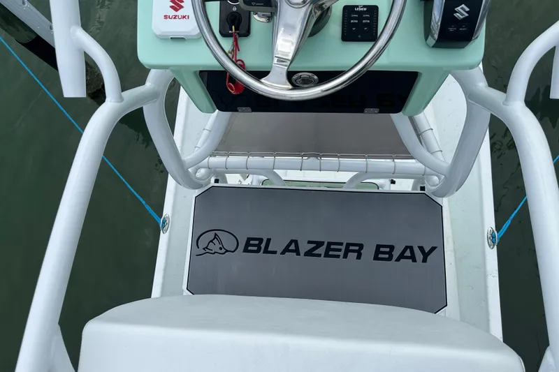 Slide: The Image of 2023 Blazer Bay 2400 boat console with Suzuki controls and steering wheel. - 11