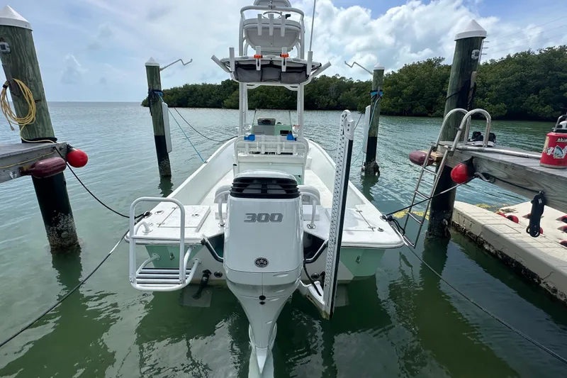 Slide: The Image of 2023 Blazer Bay 2400 boat docked, featuring a powerful 300 horsepower engine. - 19