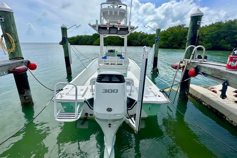 Slide: The Image of 2023 Blazer Bay 2400 boat docked, featuring a powerful 300 horsepower engine. - 23