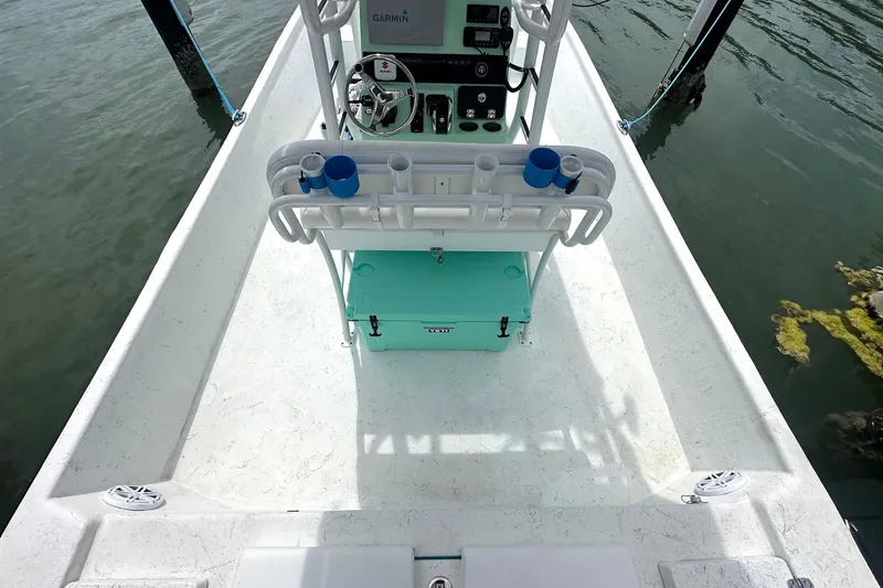 Slide: The Image of 2023 Blazer Bay 2400 boat interior with steering console and turquoise cooler. - 28