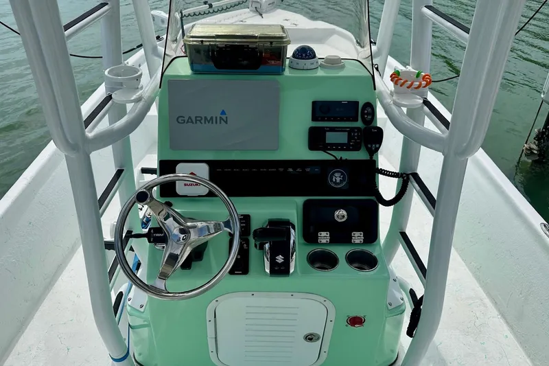 Slide: The Image of 2023 Blazer Bay 2400 boat console with Garmin navigation system and steering wheel. - 31