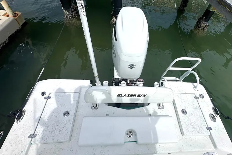 Slide: The Image of 2023 Blazer Bay 2400 boat with Suzuki outboard motor at dock. - 37
