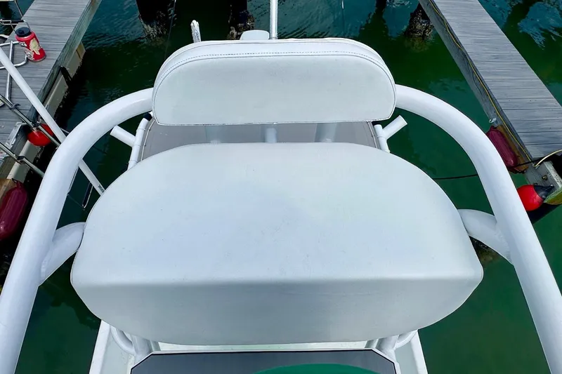 Slide: The Image of 2023 Blazer Bay 2400 boat seat, docked on calm water. - 41