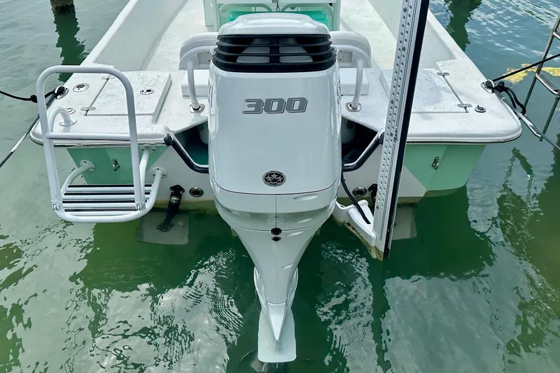 Slide: The Image of 2023 Blazer Bay 2400 boat with powerful 300 horsepower outboard motor in calm waters. - 44