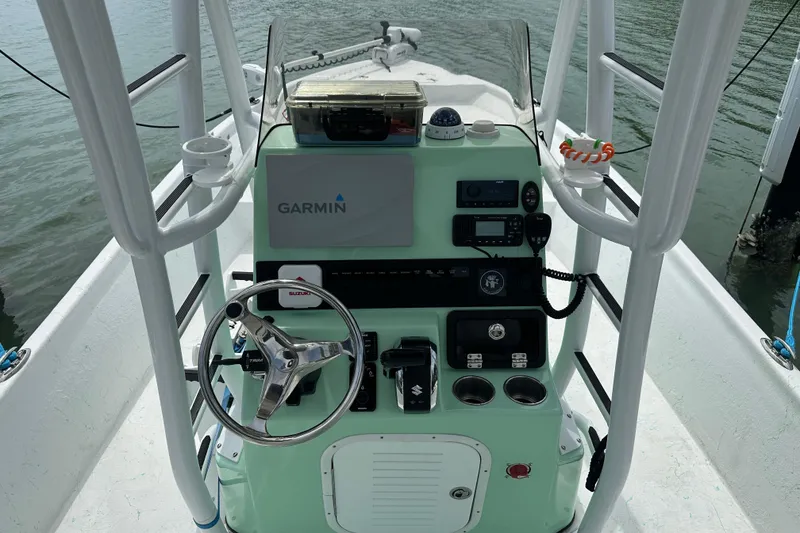 Slide: The Image of 2023 Blazer Bay 2400 boat console with Garmin navigation and Suzuki controls. - 8