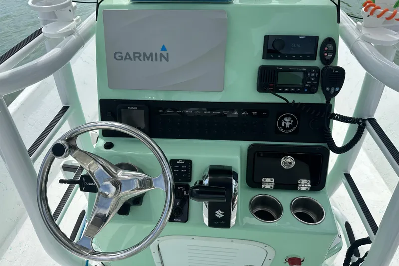 Slide: The Image of 2023 Blazer Bay 2400 boat dashboard with Garmin navigation and control panel. - 9