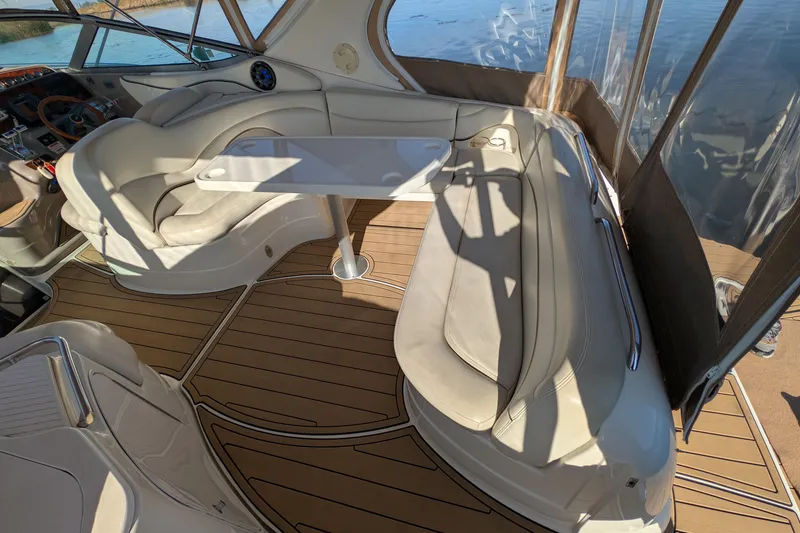 Slide: The Image of 2001 Wellcraft 3300 Martinique boat interior with seating and table, featuring elegant wood flooring. - 16