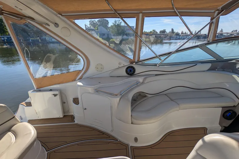Slide: The Image of 2001 Wellcraft 3300 Martinique boat interior with elegant seating and waterfront view. - 17