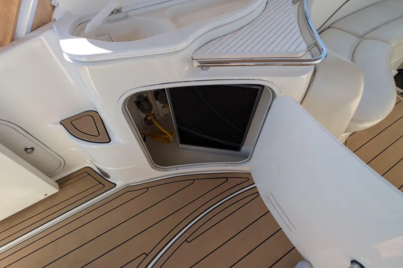 Slide: The Image of 2001 Wellcraft 3300 Martinique boat interior with open storage compartment and teak flooring. - 19