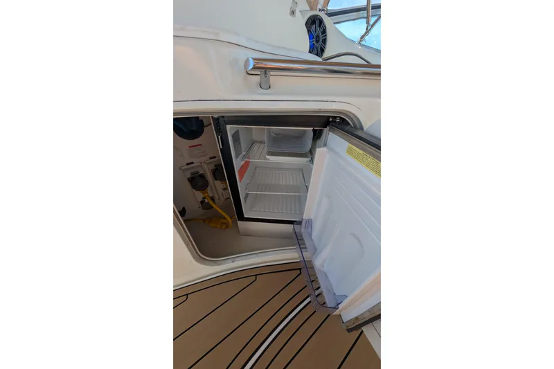 Slide: The Image of Open mini fridge on 2001 Wellcraft 3300 Martinique boat with teak flooring. - 20