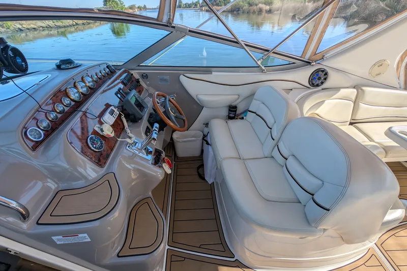 Slide: The Image of 2001 Wellcraft 3300 Martinique boat interior with luxurious seating and modern dashboard controls. - 21