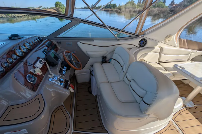 Slide: The Image of 2001 Wellcraft 3300 Martinique boat interior with luxurious seating and modern dashboard controls. - 22