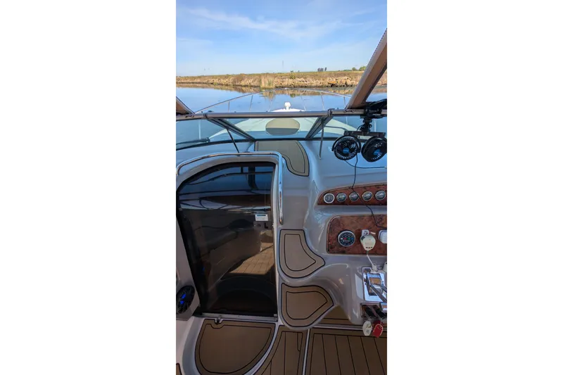 Slide: The Image of Cockpit view of 2001 Wellcraft 3300 Martinique boat with dashboard and controls. - 23