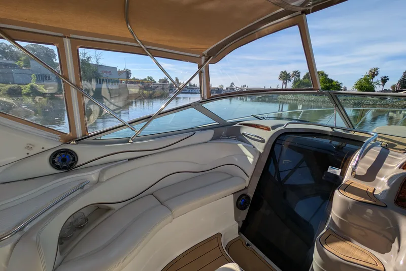 Slide: The Image of Interior view of 2001 Wellcraft 3300 Martinique yacht with luxurious seating and scenic waterway. - 24