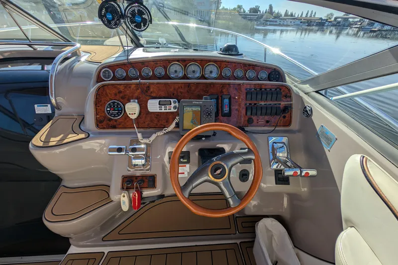 Slide: The Image of 2001 Wellcraft 3300 Martinique boat dashboard with steering wheel and control panel. - 27