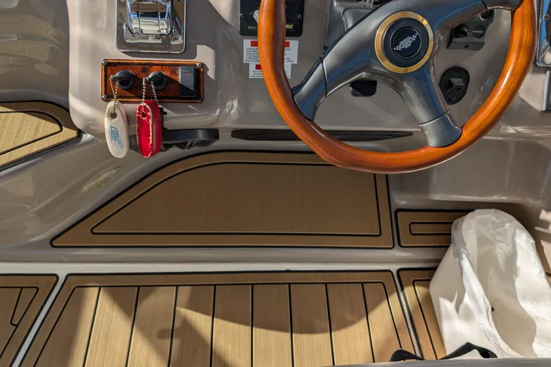 Slide: The Image of 2001 Wellcraft 3300 Martinique helm with wooden steering wheel and keychains. - 28
