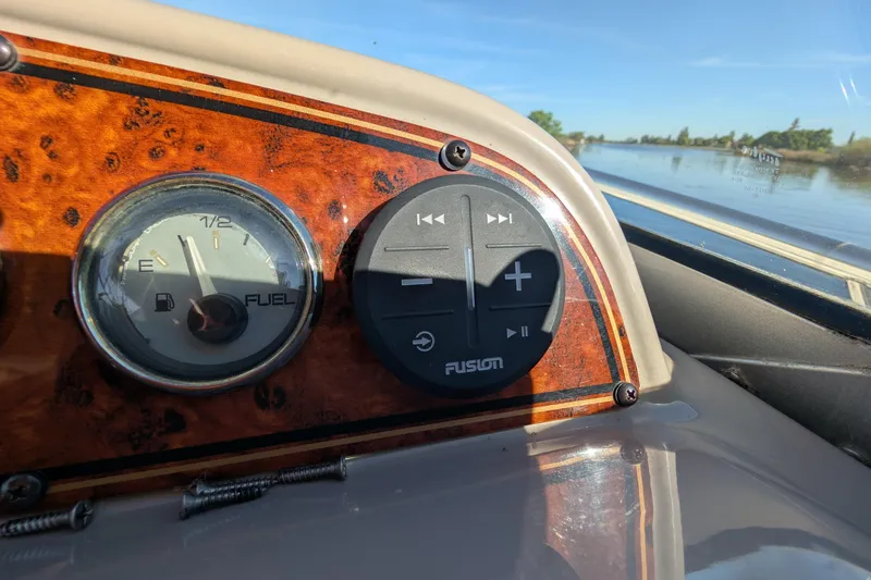 Slide: The Image of Dashboard of a 2001 Wellcraft 3300 Martinique boat with fuel gauge and audio controls. - 32