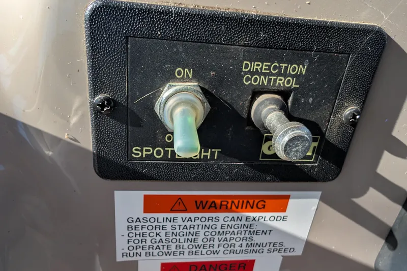 Slide: The Image of Control panel of a 2001 Wellcraft 3300 Martinique boat with spotlight and warning labels. - 35
