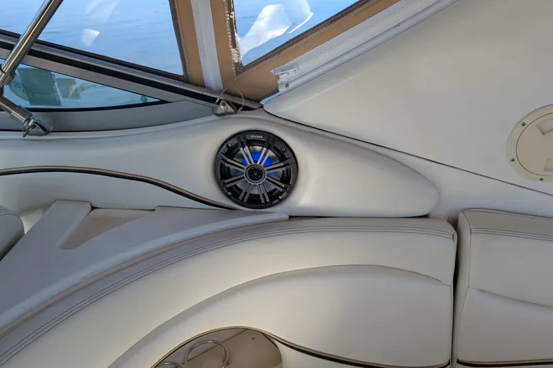 Slide: The Image of Interior of 2001 Wellcraft 3300 Martinique boat with speaker and white seating. - 37