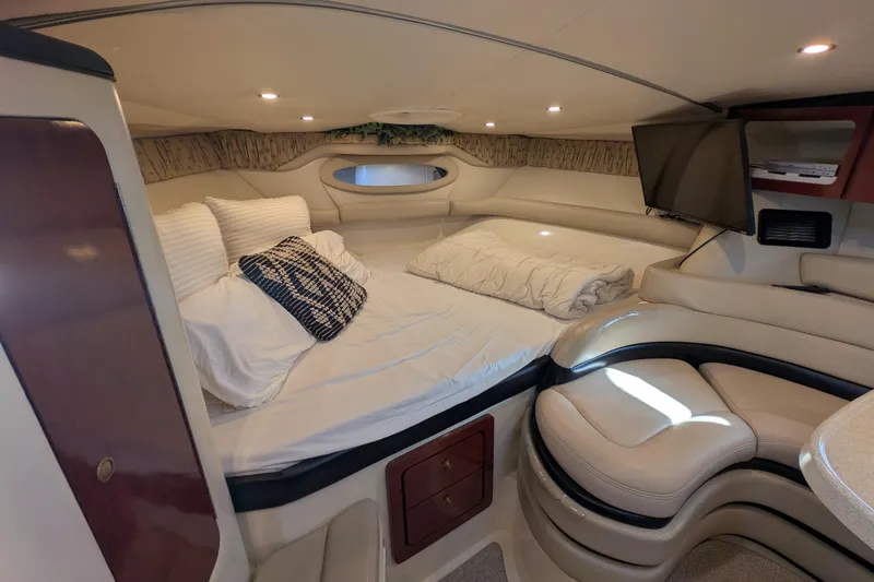Slide: The Image of Luxurious interior cabin of a 2001 Wellcraft 3300 Martinique yacht with cozy bedding. - 41