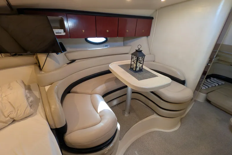 Slide: The Image of Interior of 2001 Wellcraft 3300 Martinique yacht with cozy seating and table. - 43