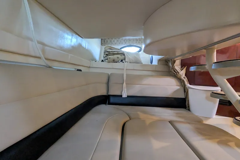 Slide: The Image of Interior of 2001 Wellcraft 3300 Martinique boat, featuring cozy seating and modern design. - 50