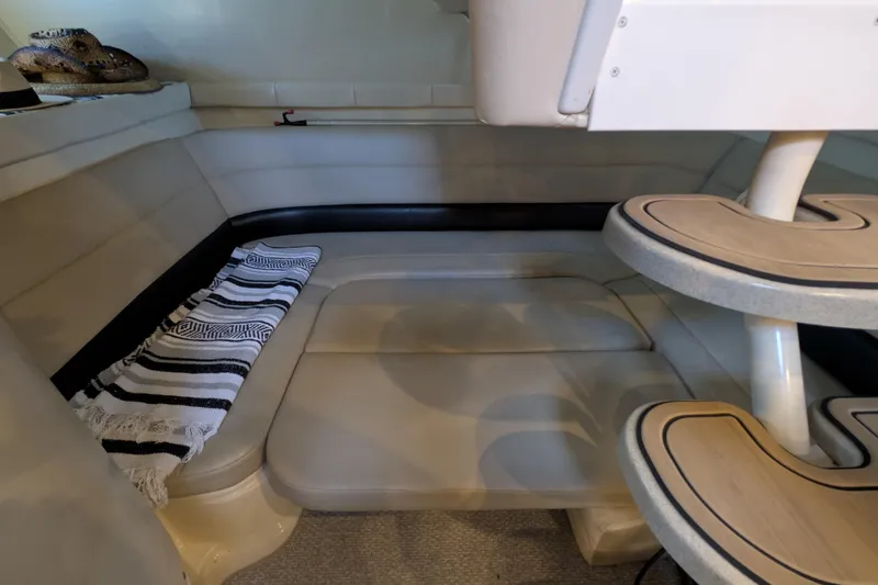 Slide: The Image of 2001 Wellcraft 3300 Martinique interior with beige seating and striped blanket. - 51