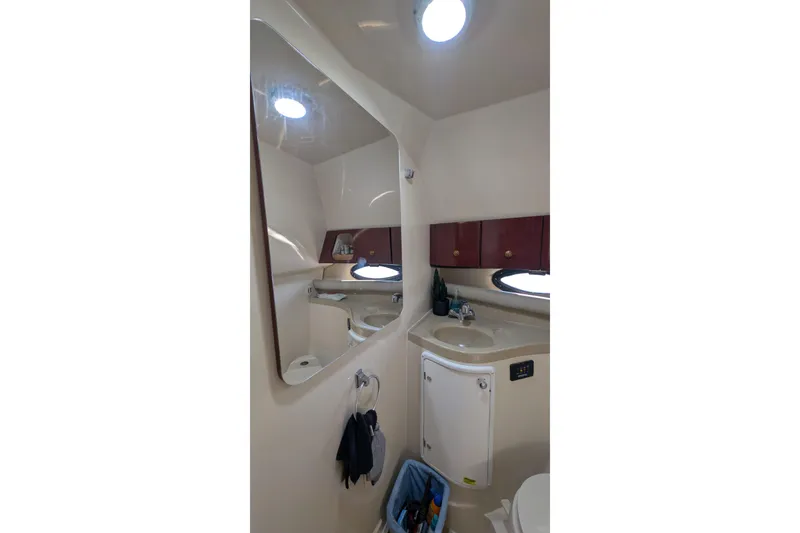 Slide: The Image of 2001 Wellcraft 3300 Martinique bathroom with mirror, sink, and storage cabinets. - 53