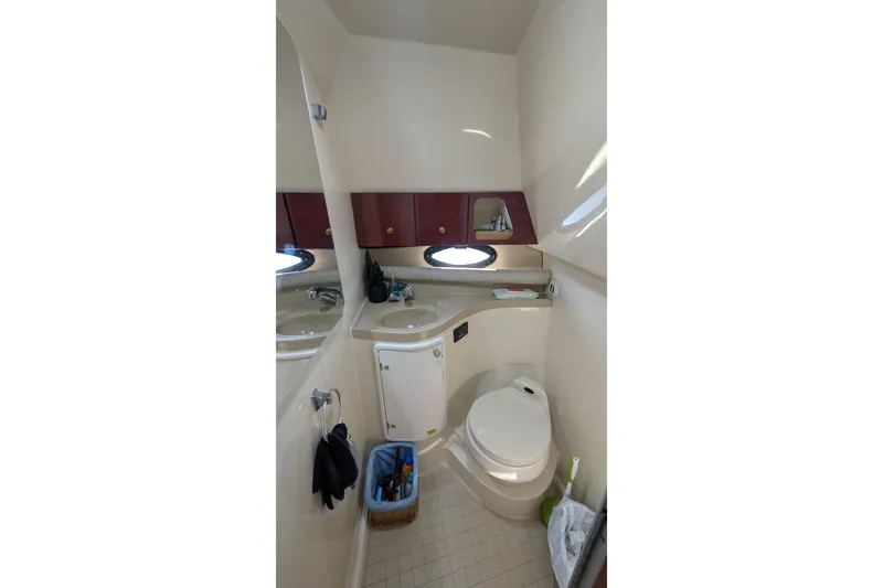 Slide: The Image of 2001 Wellcraft 3300 Martinique bathroom interior with sink, toilet, and storage cabinets. - 54