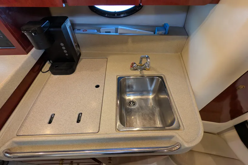 Slide: The Image of 2001 Wellcraft 3300 Martinique yacht kitchenette with sink and coffee maker. - 58