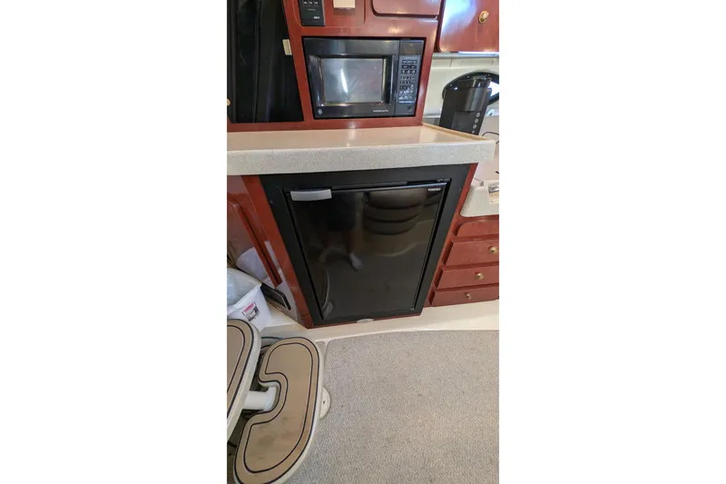 Slide: The Image of 2001 Wellcraft 3300 Martinique yacht kitchen with microwave and fridge. - 60