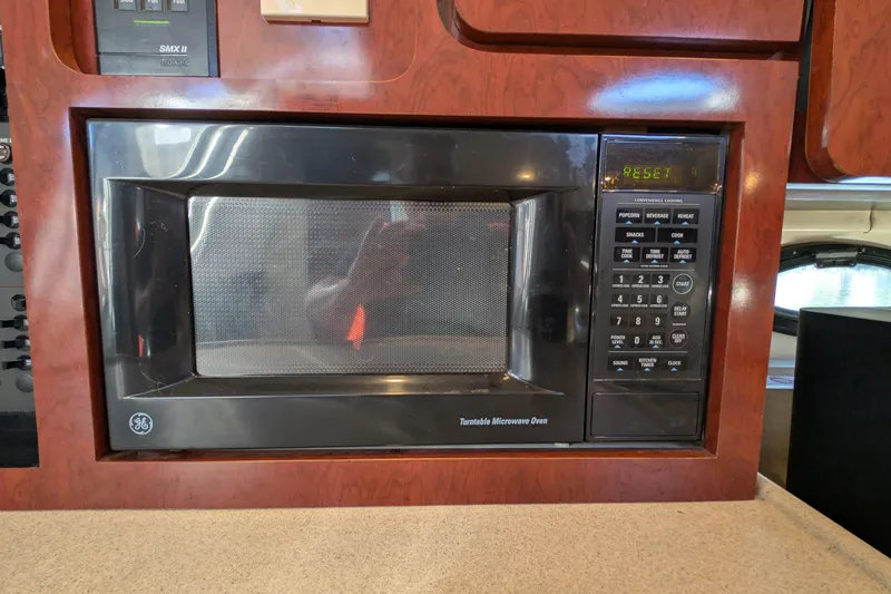 Slide: The Image of Built-in GE microwave in 2001 Wellcraft 3300 Martinique boat kitchen. - 61