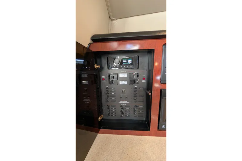 Slide: The Image of Electrical panel inside 2001 Wellcraft 3300 Martinique boat, featuring various switches and controls. - 63